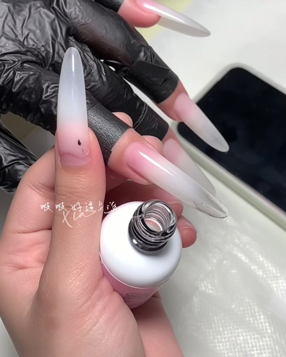 A brush being used to refine the polish edge near the cuticle.