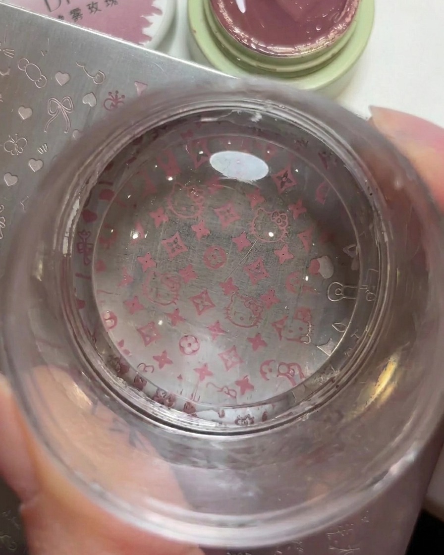A clear jelly stamper showing the picked-up Hello Kitty and logo pattern clearly.