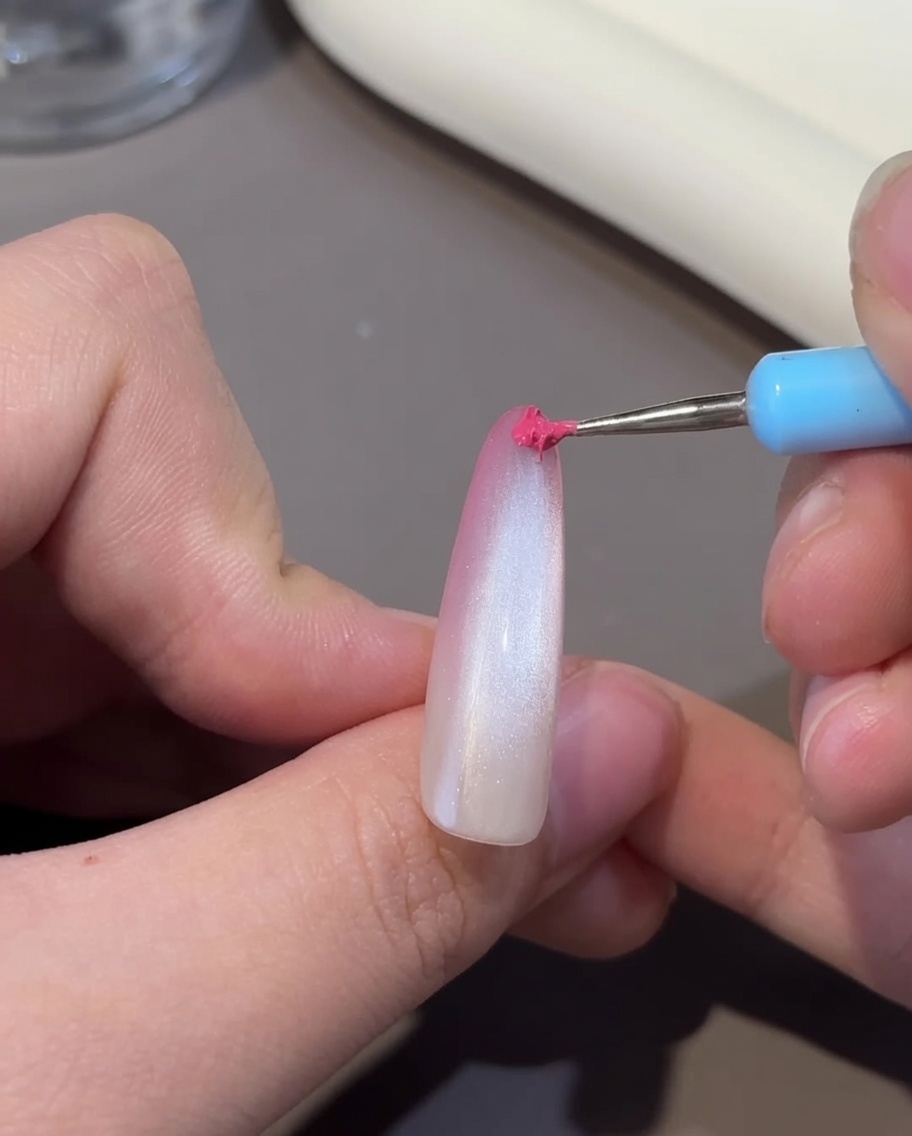A nail with the cat-eye effect being cured inside a UV/LED lamp.