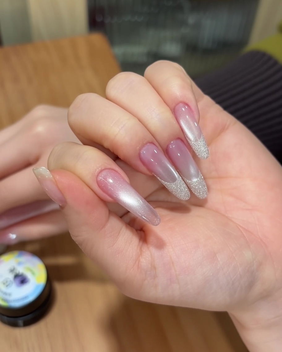 Nails positioned inside a portable UV lamp for the curing process.