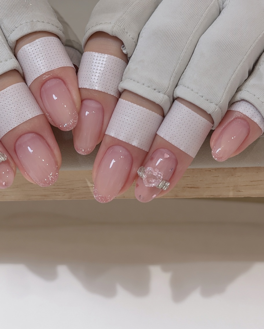 A second layer of magnetic polish being applied to the nail tips, enhancing the overall shimmer.