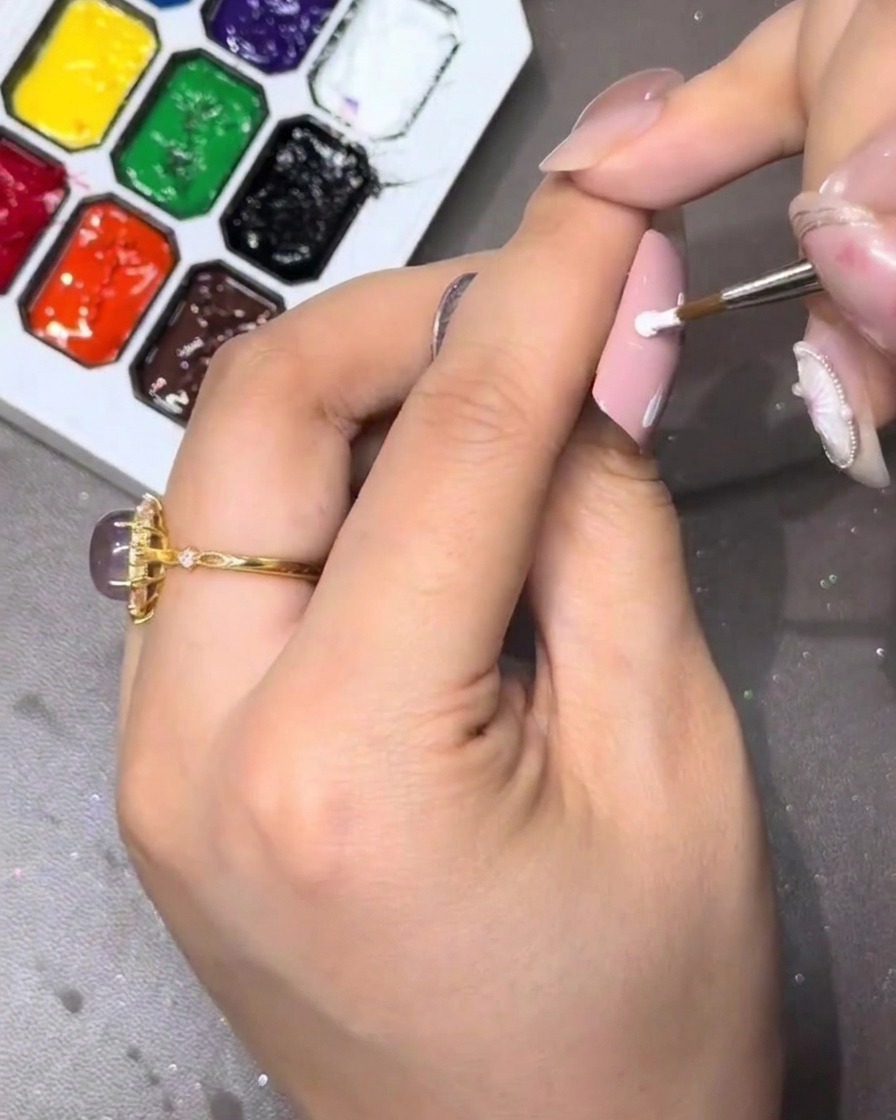 A close-up showing the three petals forming on the nail.