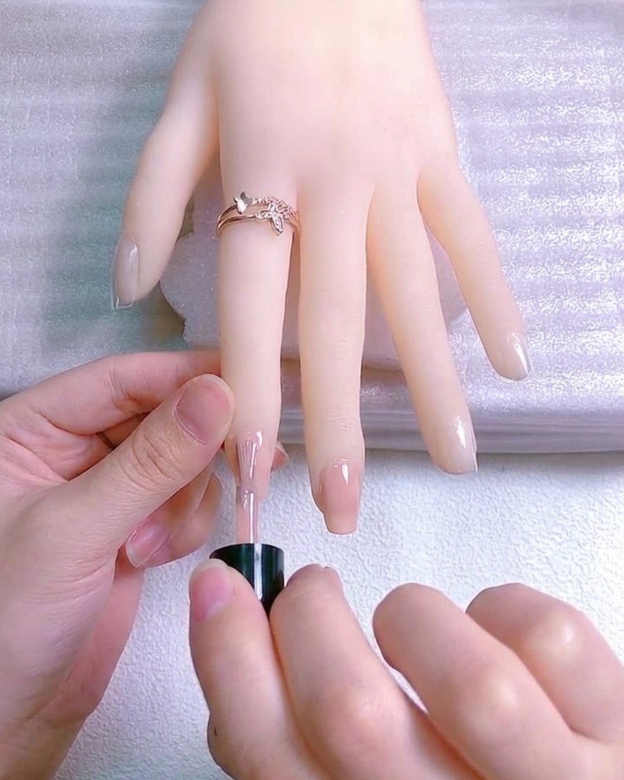 A thin layer of reflective glitter polish applied to the free edge of the nail.