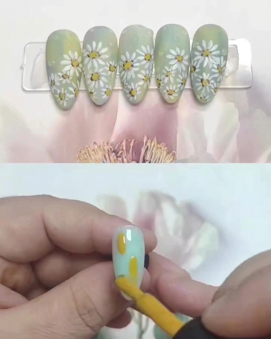 Adding a tiny brown dot to the center of a painted daisy on a nail tip.