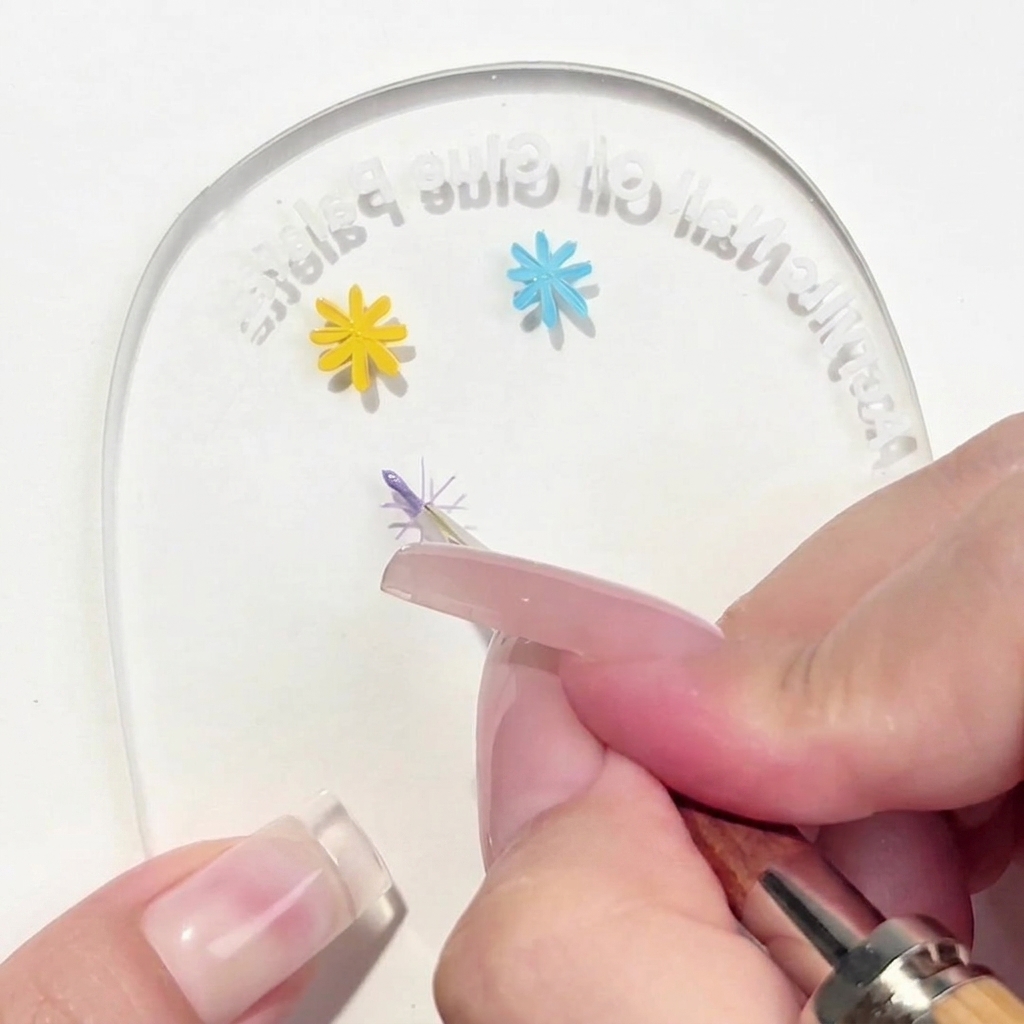 A liner brush applying a single purple petal to the center cross guide on a palette.