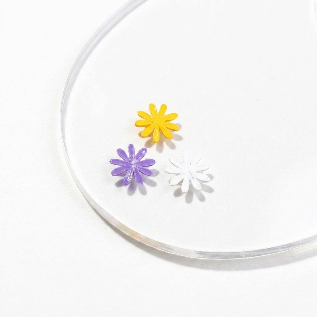 A liner brush applying a fourth purple petal to the daisy design on the palette.
