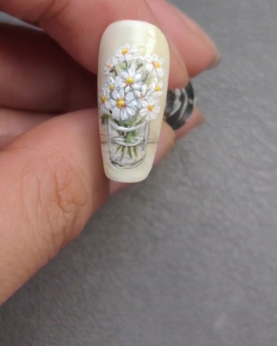 The finished daisy bouquet nail art design, showcasing refined stems and bright floral highlights.