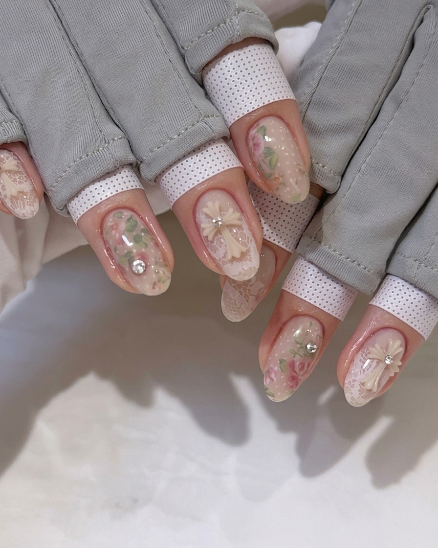 A brush applying a clear, glossy top coat over the detailed nail art design.