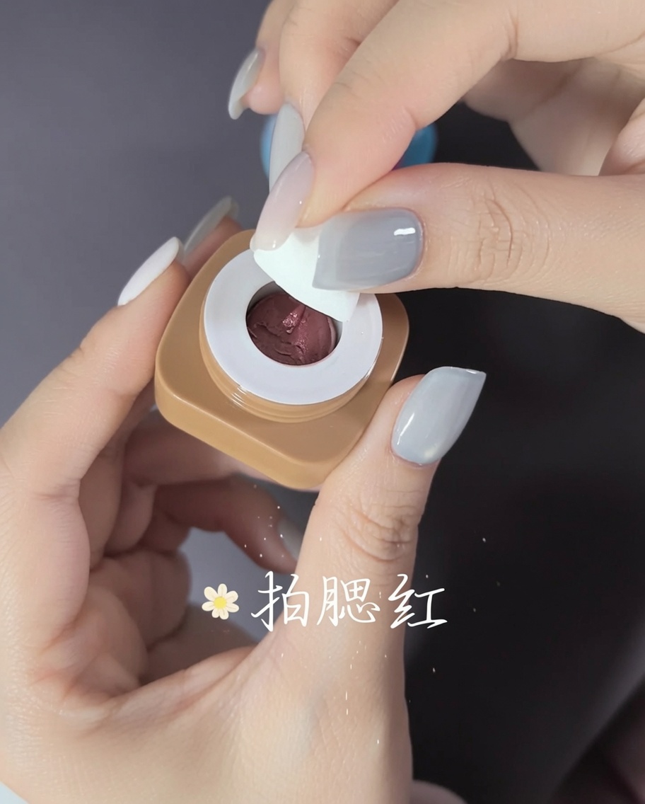 A close-up showing adhesive being applied to the inside of a clear plastic nail tip.