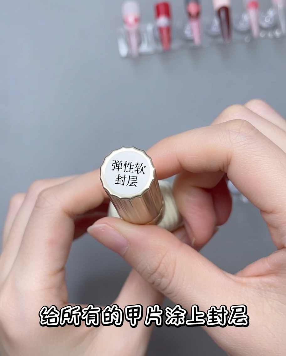 A brush applying a layer of clear, glossy top coat over a nail that has a white lace design.