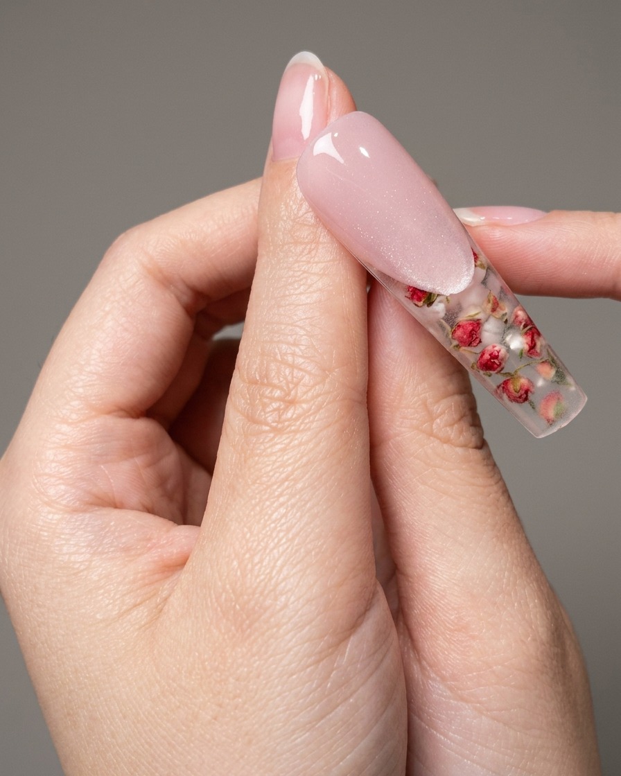 A hand placed inside a UV nail lamp, with the fingers clearly visible under the purple glow.