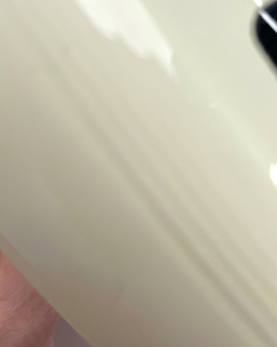 A view of a clear nail tip being cured under the purple light of a UV/LED nail lamp.