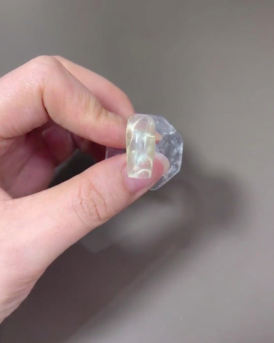 A nail placed inside a UV/LED lamp for curing.