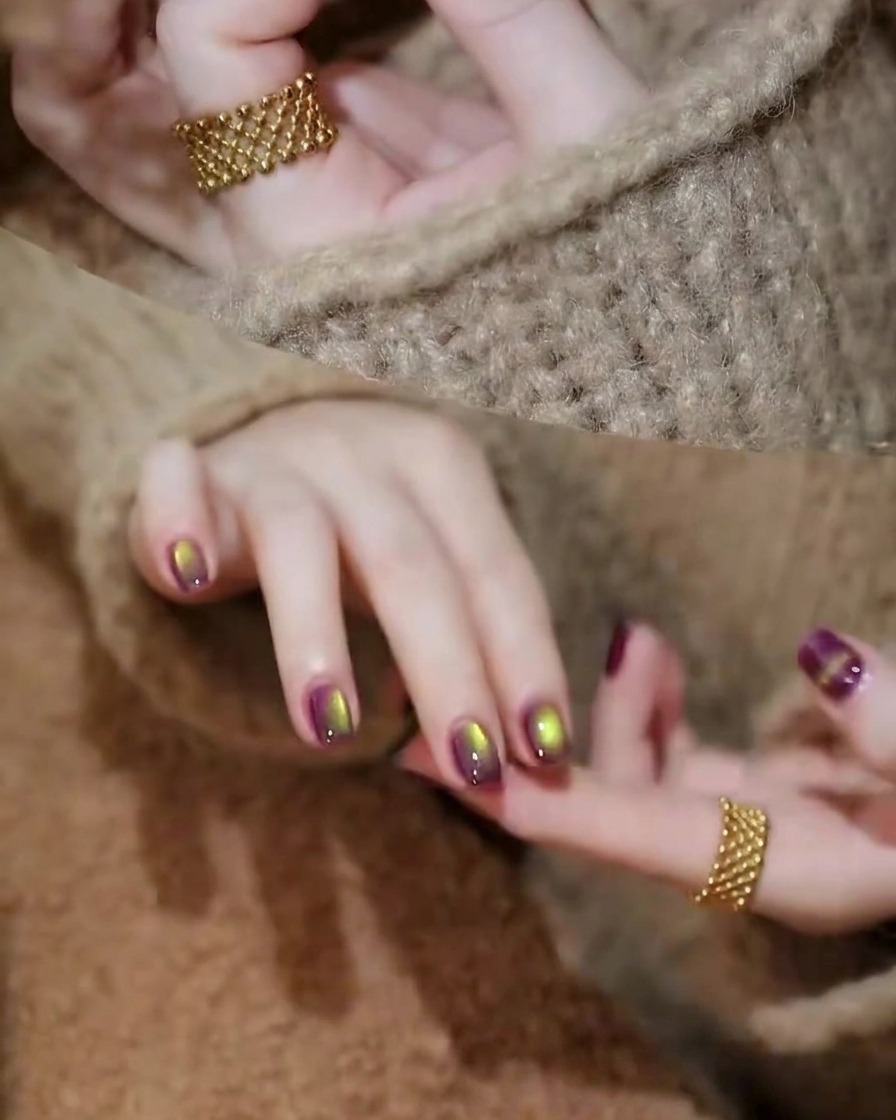 A hand resting inside a professional UV/LED nail lamp with purple gel applied to the nails.