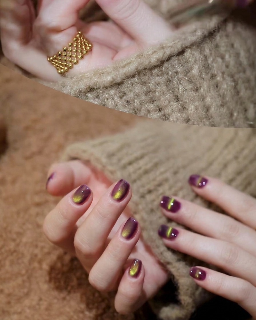 A magnetic tool held diagonally above a fingernail with wet purple cat-eye gel, showing the particles shifting.