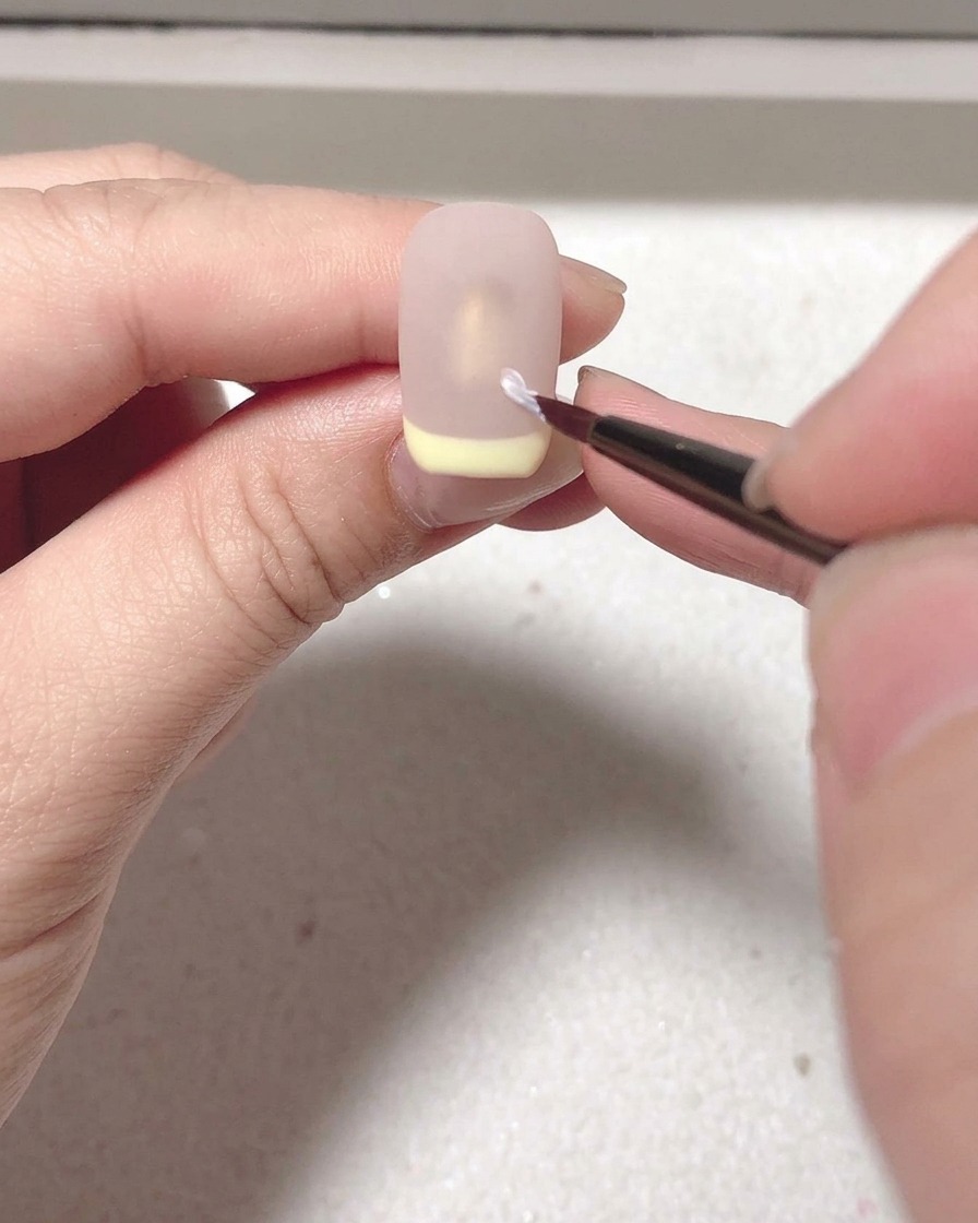 The nail with the matte top coat curing inside the UV/LED lamp.