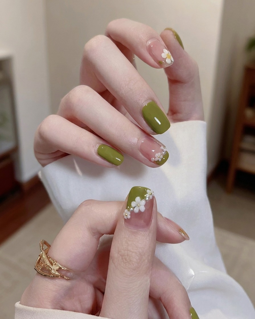 A small drop of clear gel being placed on the surface of a painted nail.