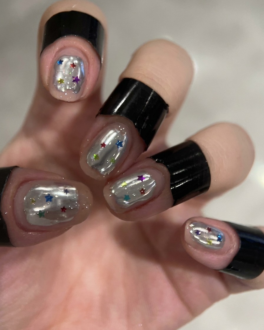A hand inside a UV/LED nail lamp with the light illuminated.