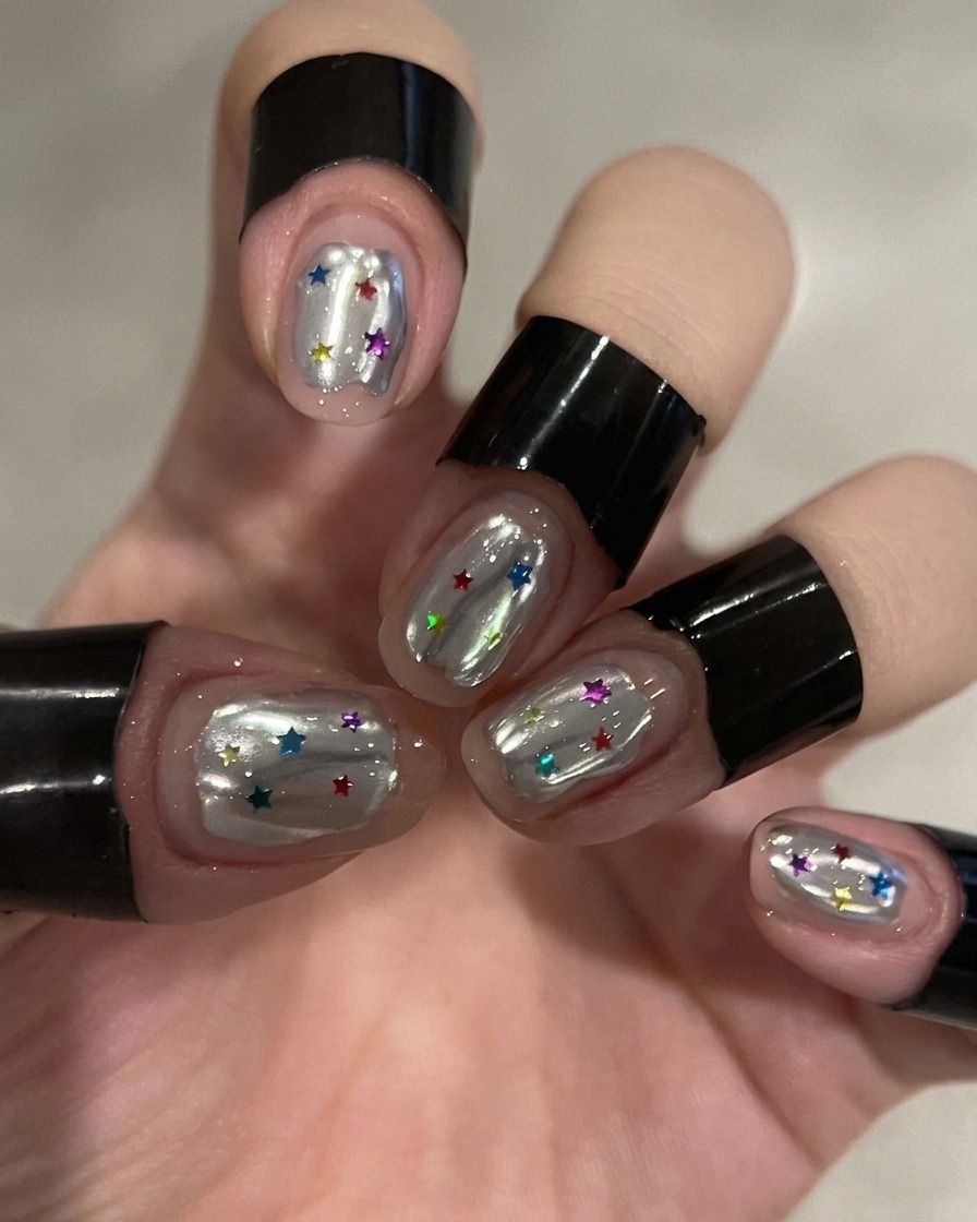 Nails inside a UV lamp curing the chrome finish.