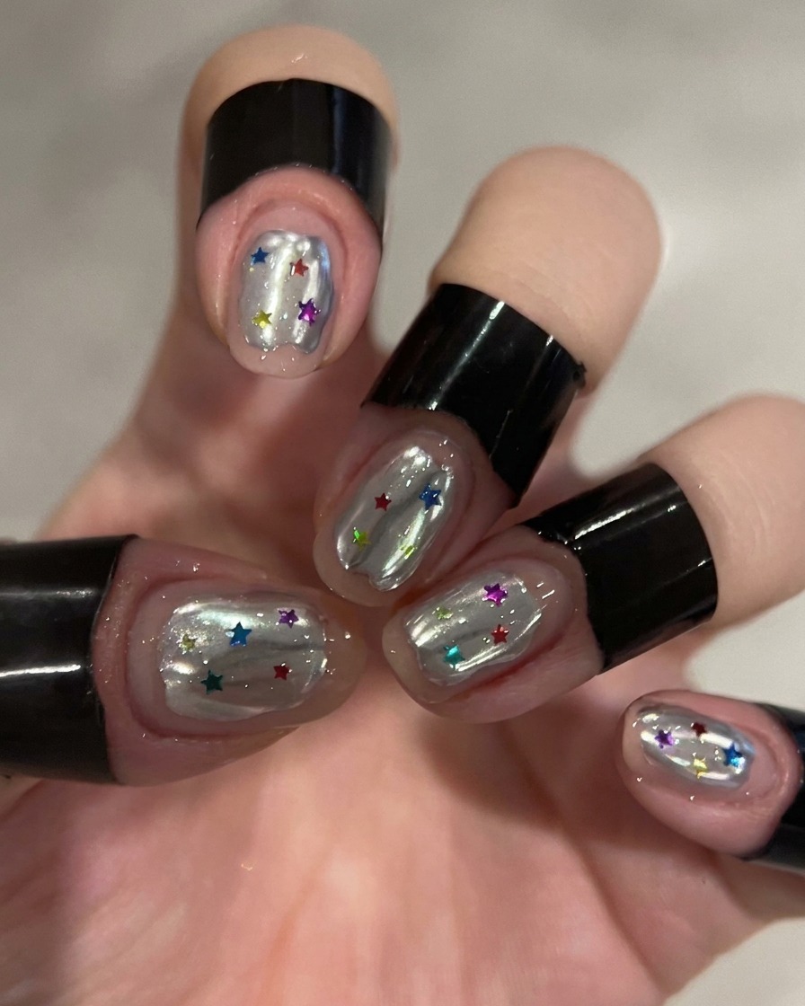 A close-up of a nail being coated with a clear, purple-tinted builder gel using a brush, creating a glossy, dimensional finish.