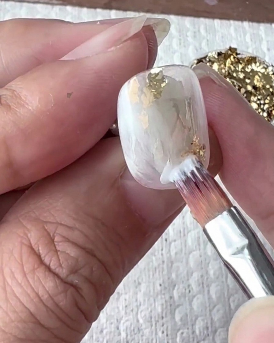 The nail being cured inside a UV/LED nail lamp.