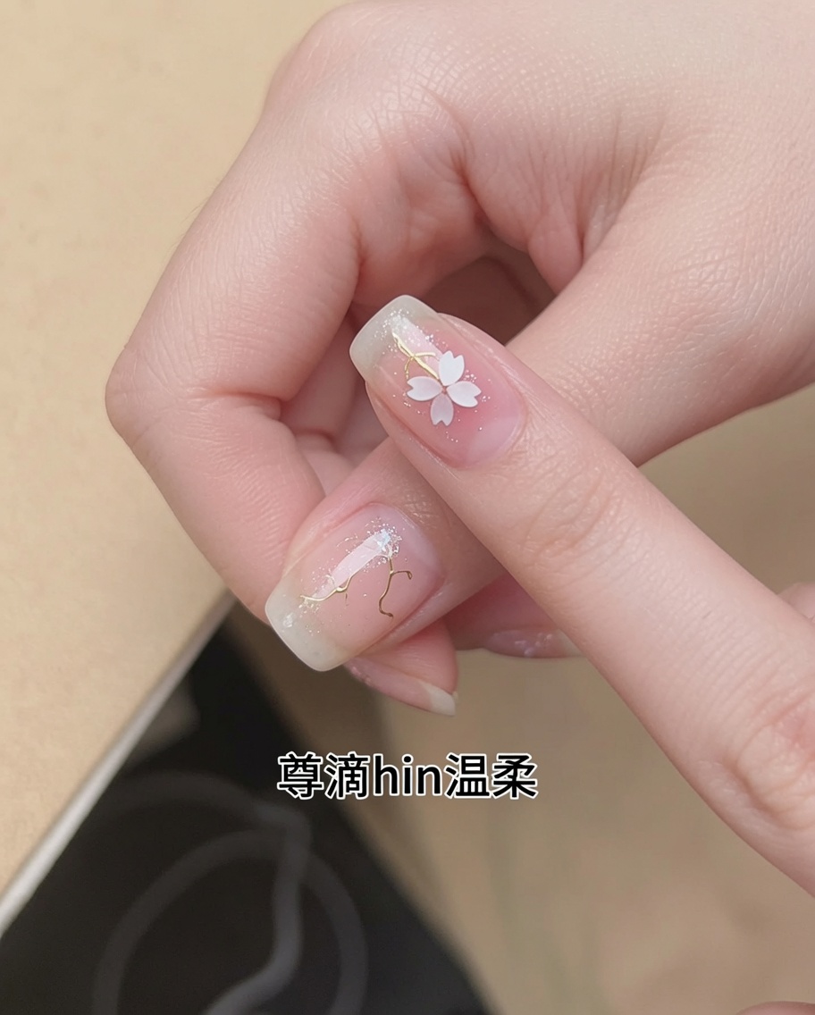 A brush applying a sheer, translucent nude gel polish to a natural fingernail.
