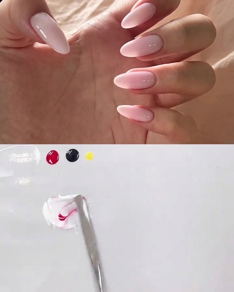A metal spatula blending white and pink gel on a clean white palette.