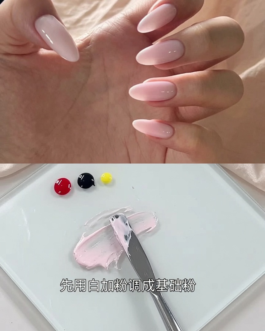 The spatula blending the black gel into the pink mixture until the color becomes a consistent muted grayish-pink.