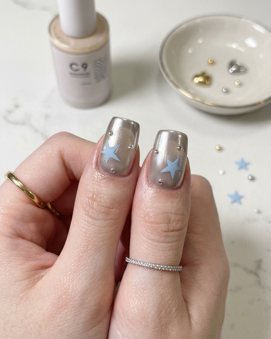 A brush applying silver magnetic cat-eye gel to the tip of a nail.