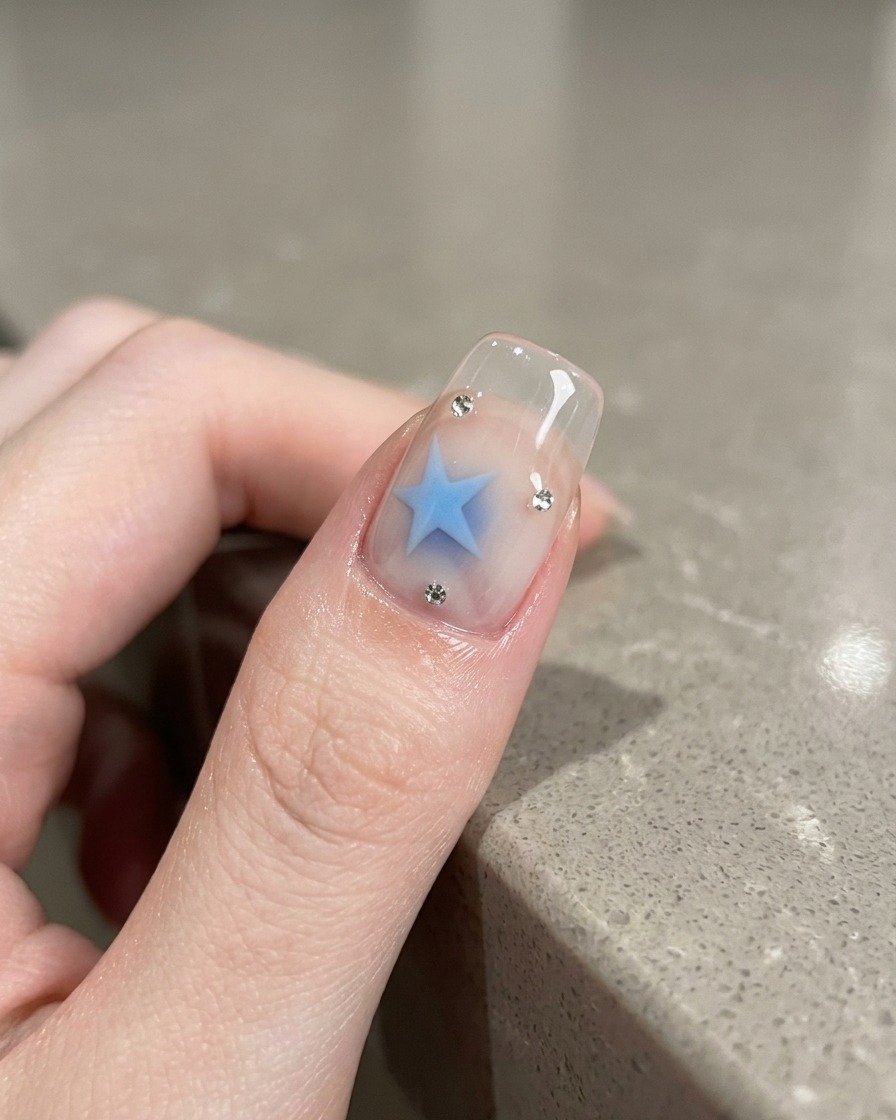 Using a magnetic tool to manipulate the silver cat-eye pigment on the nail.