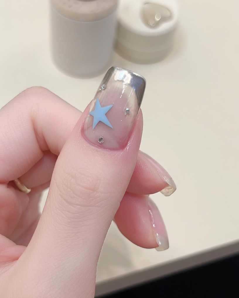Using a thin magnet tool to sharpen the cat-eye line on the nail.