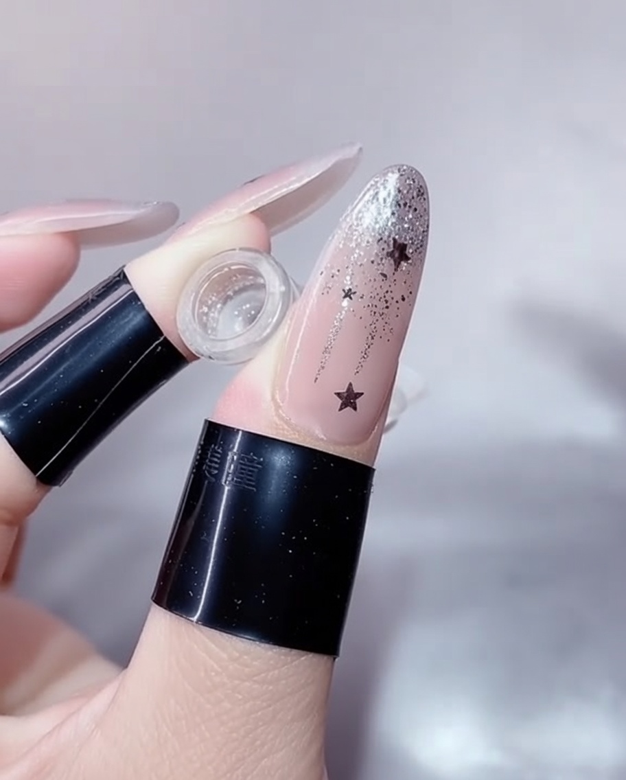 A close-up of a manicured nail resting inside a professional UV/LED nail lamp, with the light turned on, showing the curing process.