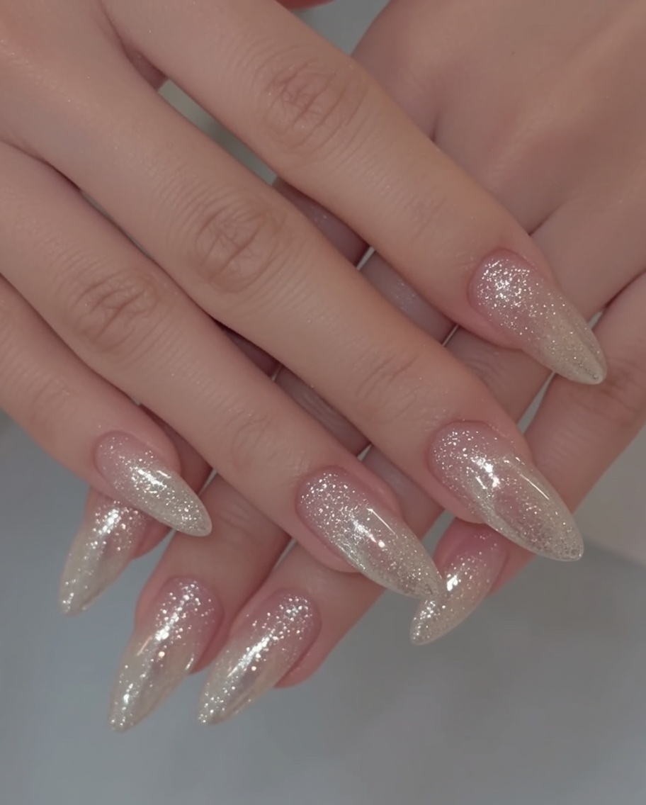 A detail tool placing clear, thick building gel beads onto a finished chrome nail to simulate water droplets.