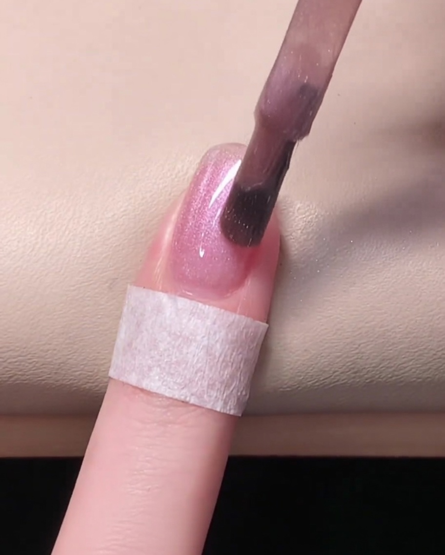 A nail illuminated inside a UV/LED lamp, curing the gel polish.