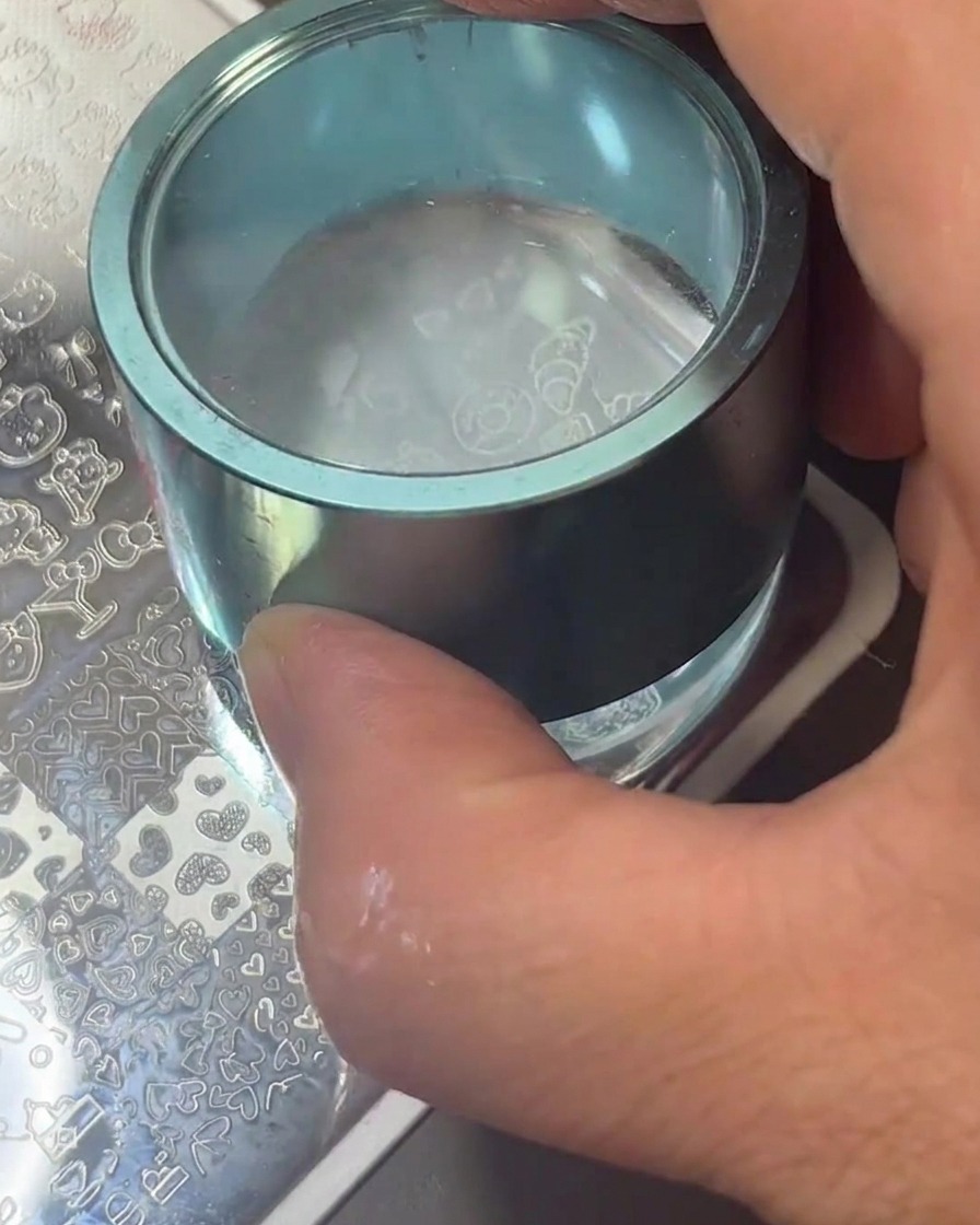 A clear silicone stamper showing the white food icon designs successfully transferred to its surface.