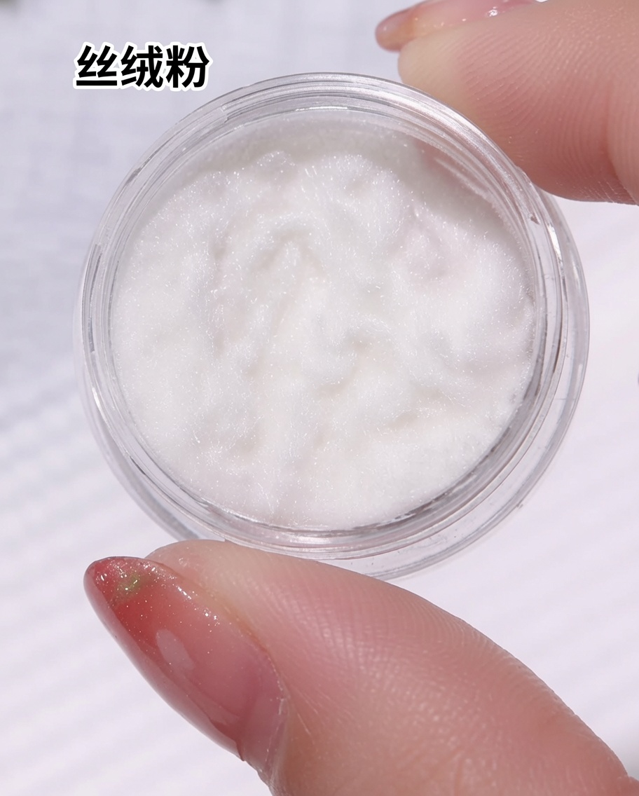 A small jar containing fine, white, fuzzy velvet powder being held, with a close-up of the texture inside the container.