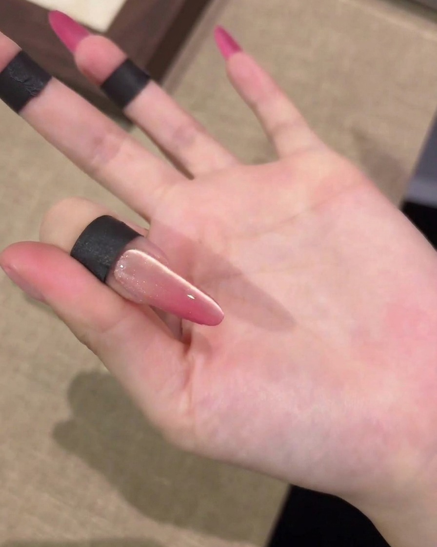 A magnet sweeping left and right over a nail to create a light reflection.
