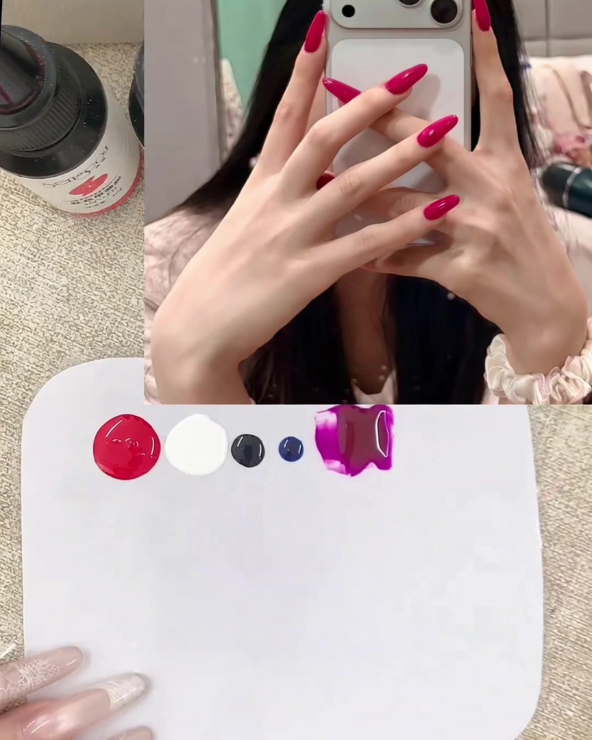 A close-up of a metal spatula placing dollops of vibrant red and opaque white gel onto a clean white mixing palette.