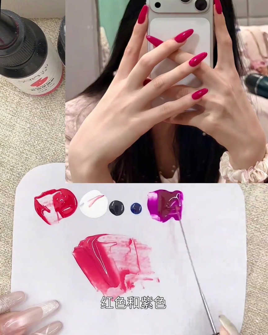 A tiny amount of black gel being integrated into the berry-toned pink mixture on the palette.