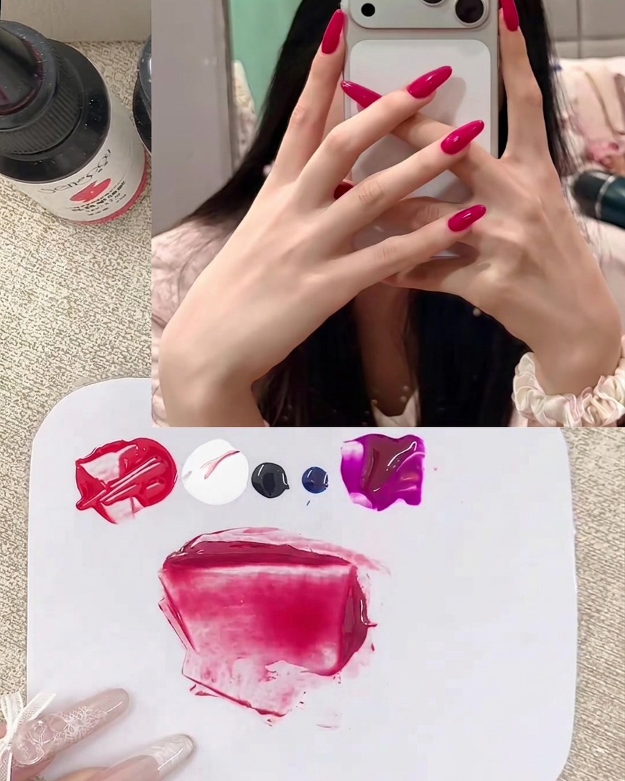 A close-up view of clear mixing gel being added to the berry red gel mixture on the palette.