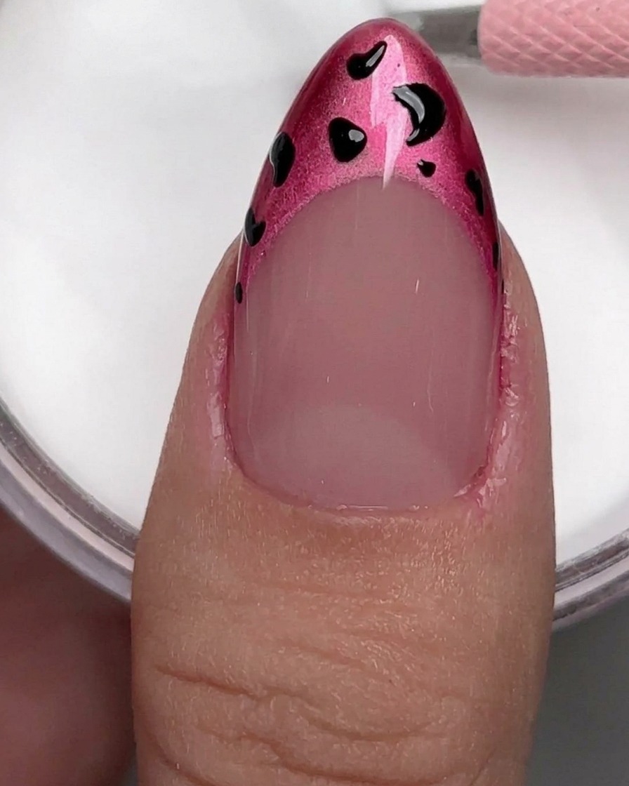 A close-up of a nail buffer being used on a natural fingernail to remove shine.