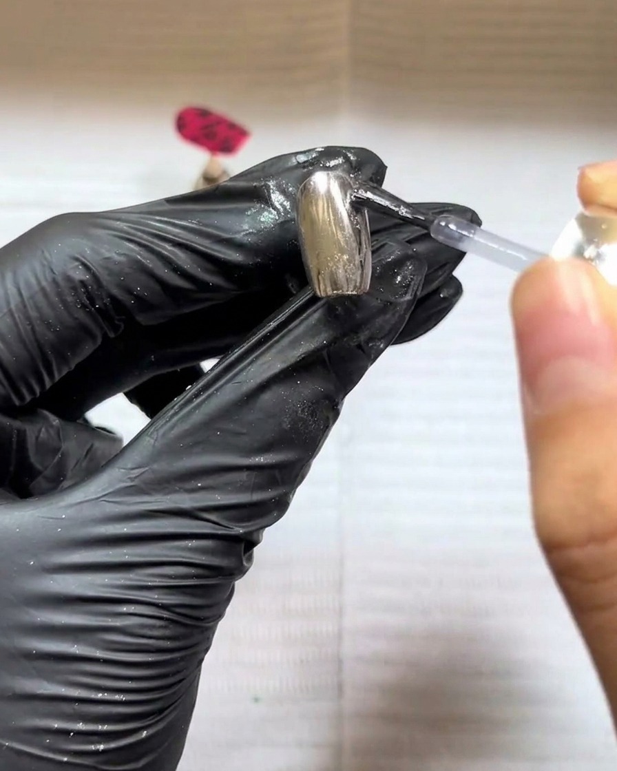 A fluffy brush sweeping away excess powder to show the final raised texture.