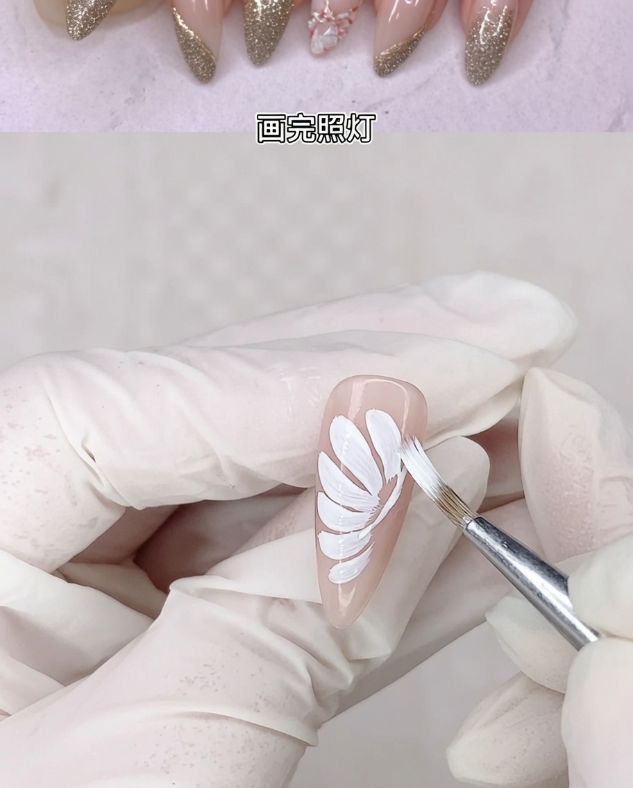 The nail with the white daisy petals being cured inside a UV lamp.
