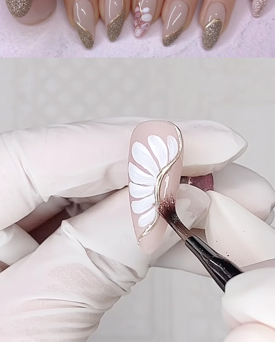 A liner brush applying a strip of clear adhesive gel down the side of a nail with floral art.