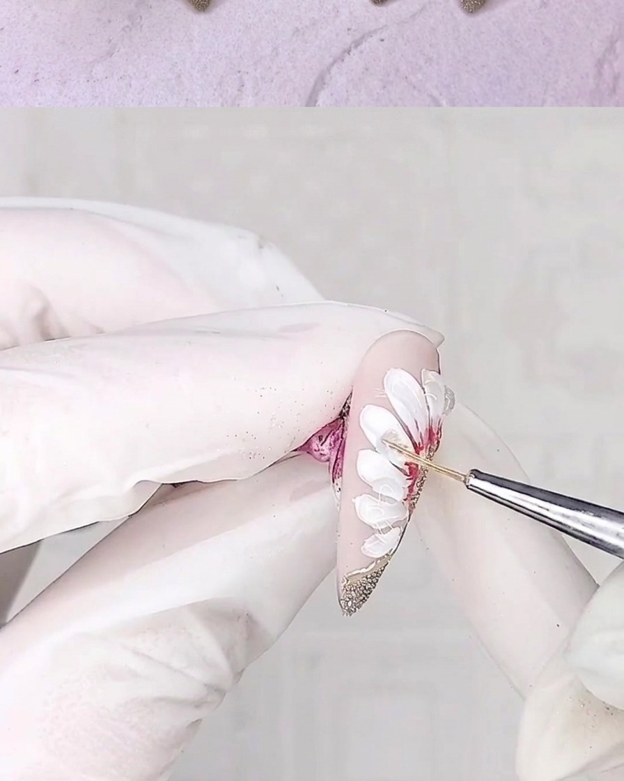 A liner brush applying a second layer of adhesive gel to the petal edges to enhance depth.