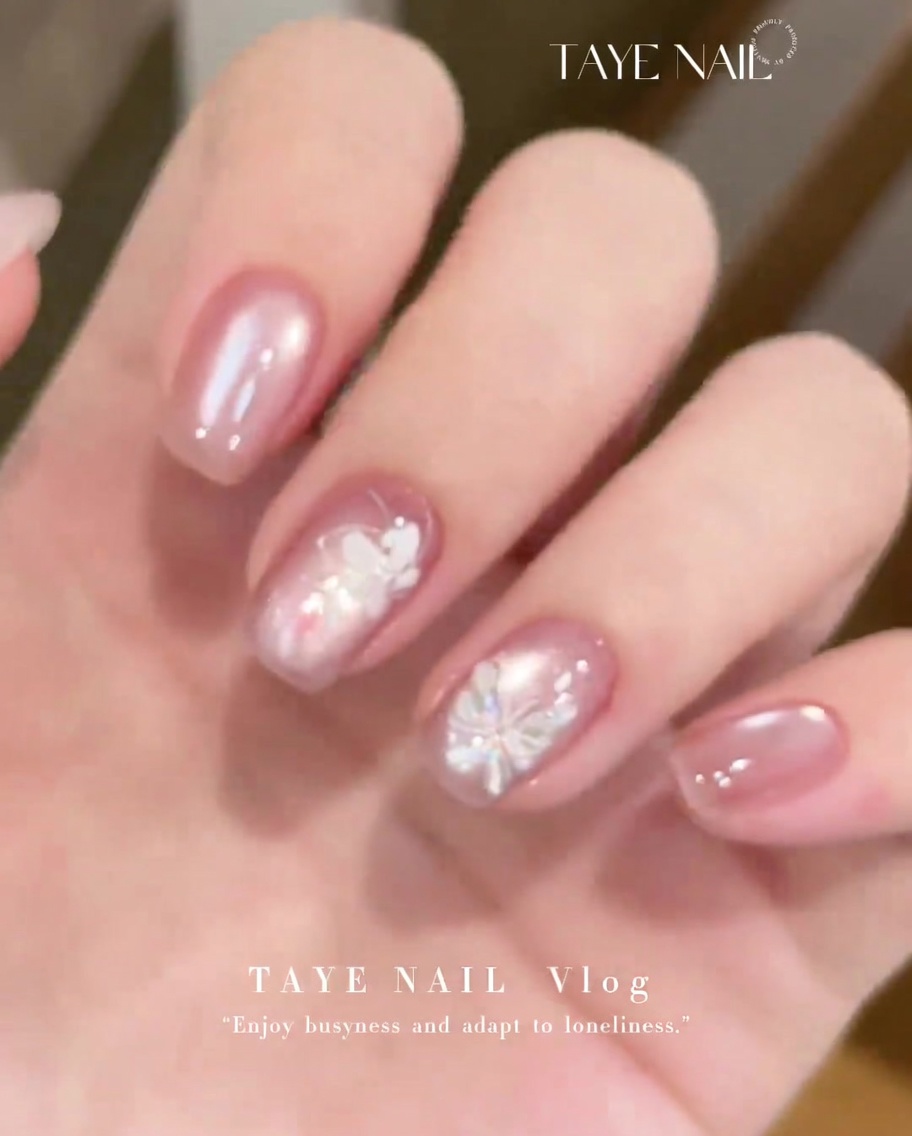 A flat gel brush applying a sheer layer of E225 cat-eye gel to a prepared natural nail.
