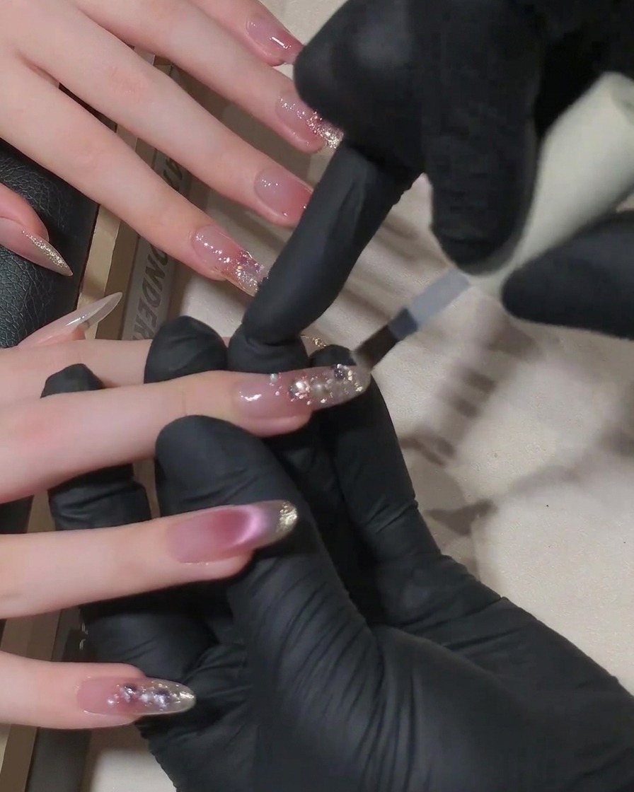 A close-up view of nails inside a professional UV nail lamp during the final curing process.