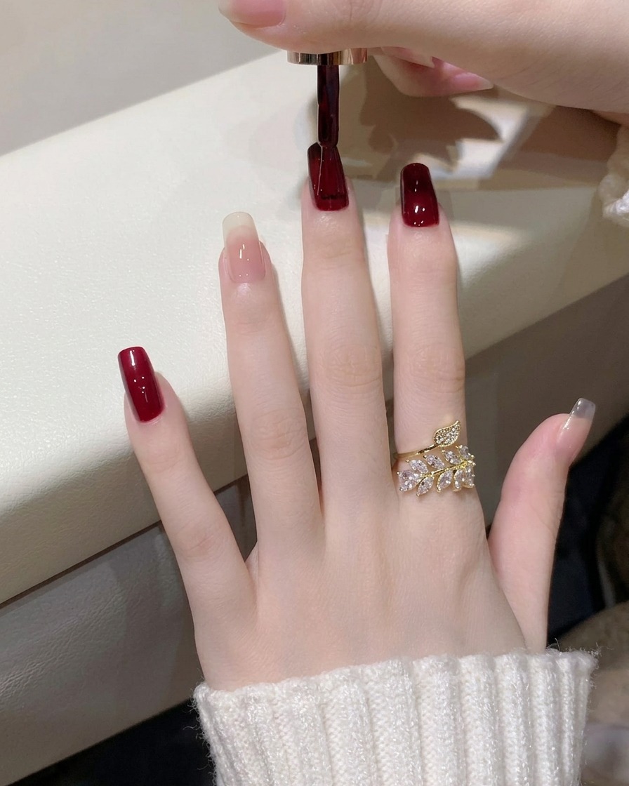 A hand resting inside a professional UV/LED nail lamp with the light turned on.
