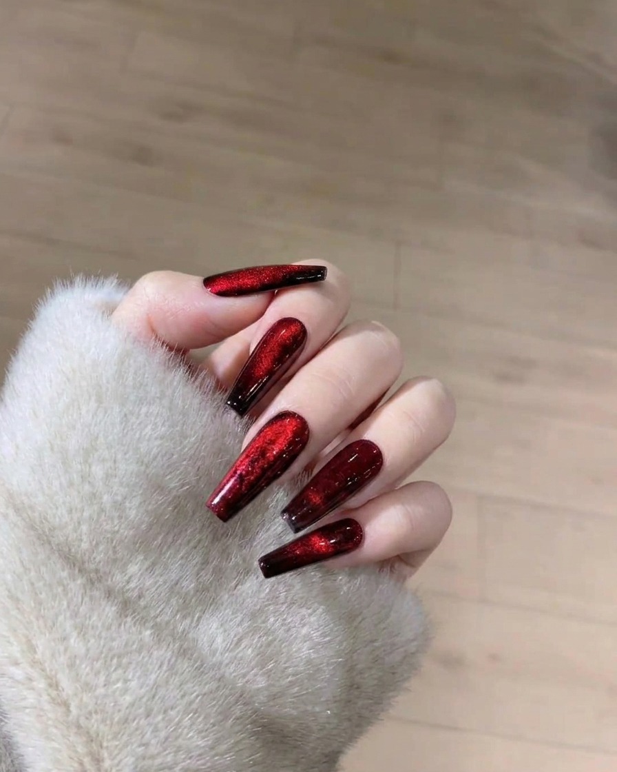 A set of nails with the cat-eye effect inside an LED lamp, mid-curing process.