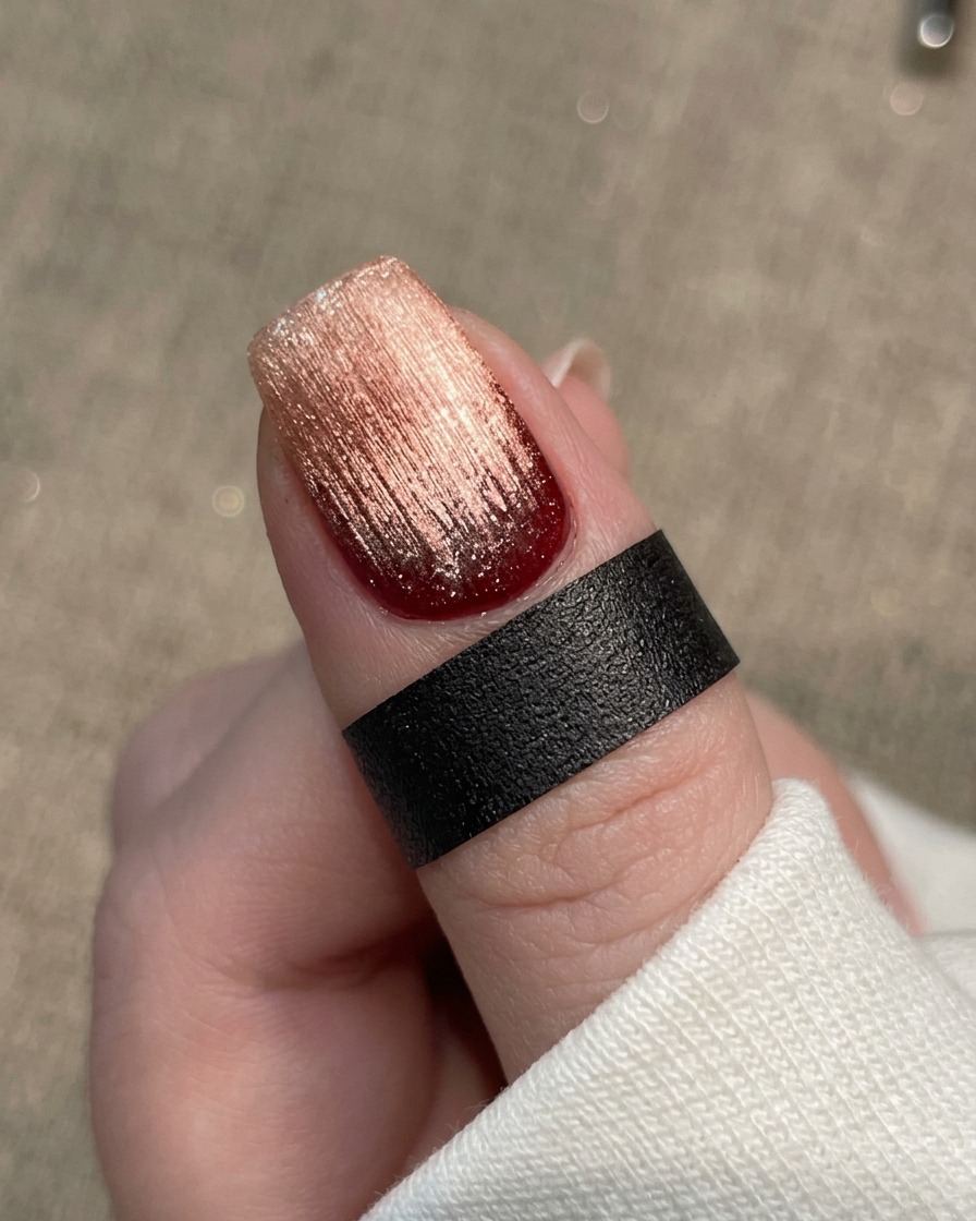 A close-up view of a brush applying a clear, glossy base gel onto a clean, prepared natural nail.